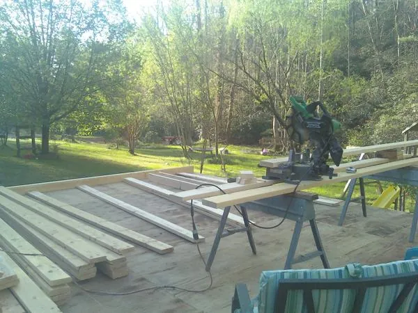 Miter saw and framing lumber on a deck under construction in Red Hook