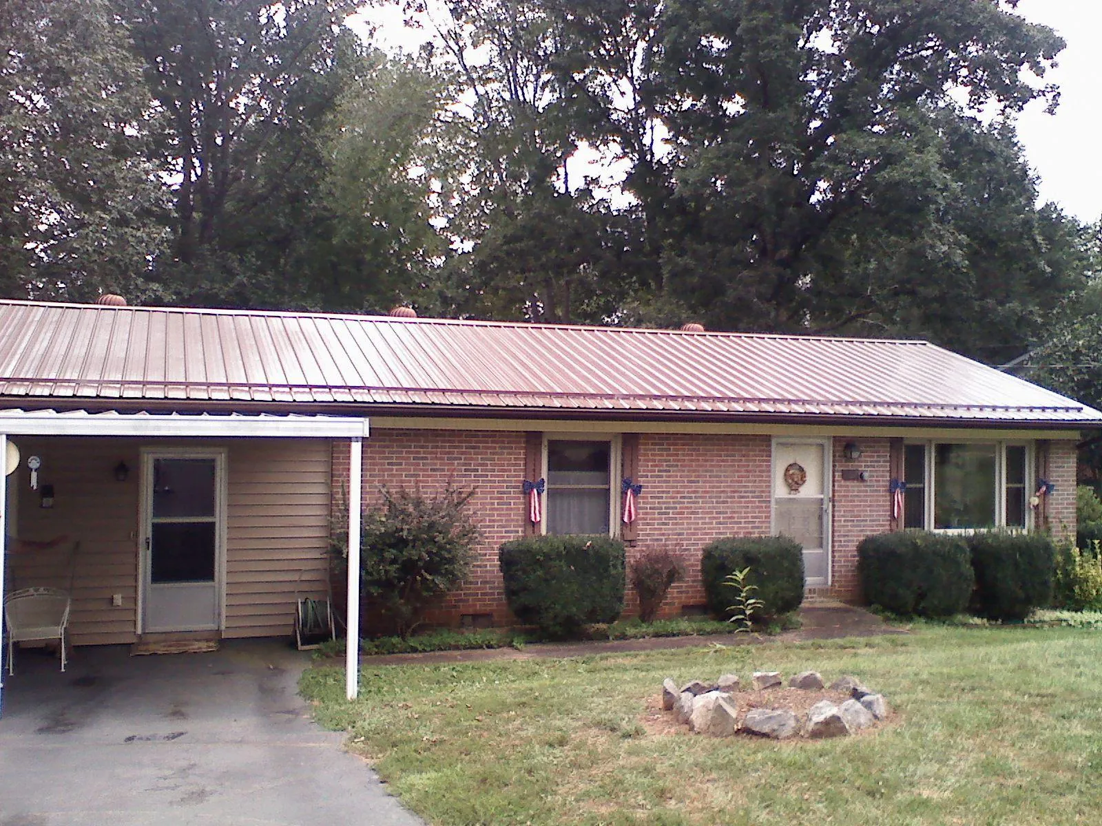 Bronze metal roof and carport on a brick ranch home — Roof Repair work by our crew in Red Hook